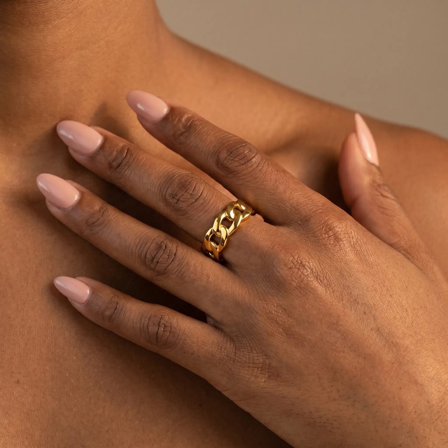 Woman wearing Cuban Link Gold Band Ring - studio close-up editorial