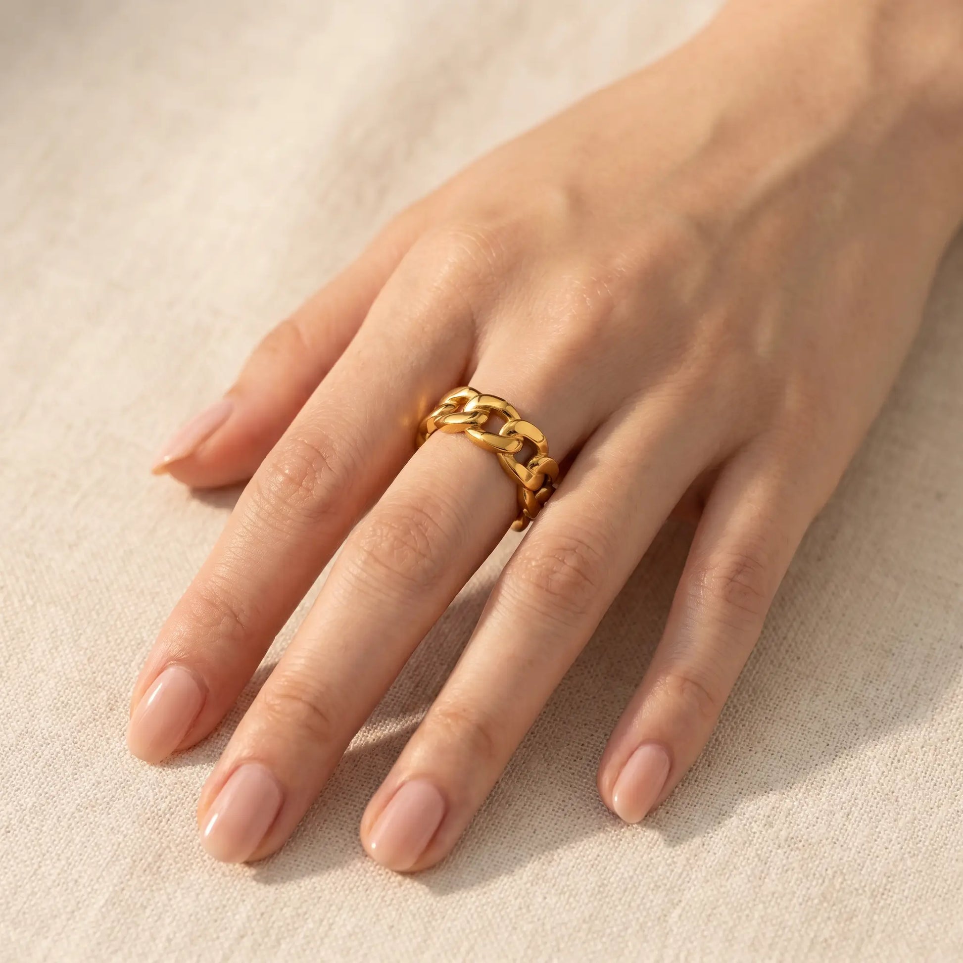 Cuban Link Gold Band Ring on hand - 3/4 studio portrait