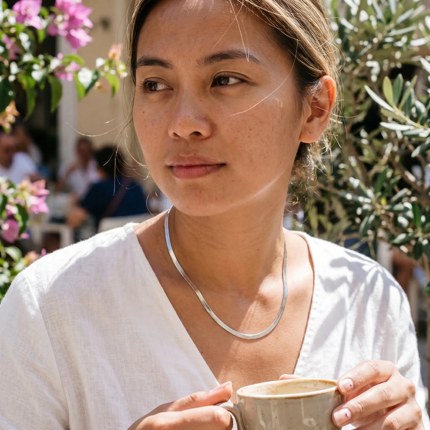 AUREATE 5mm Herringbone silver chain at Mediterranean cafe terrace morning editorial