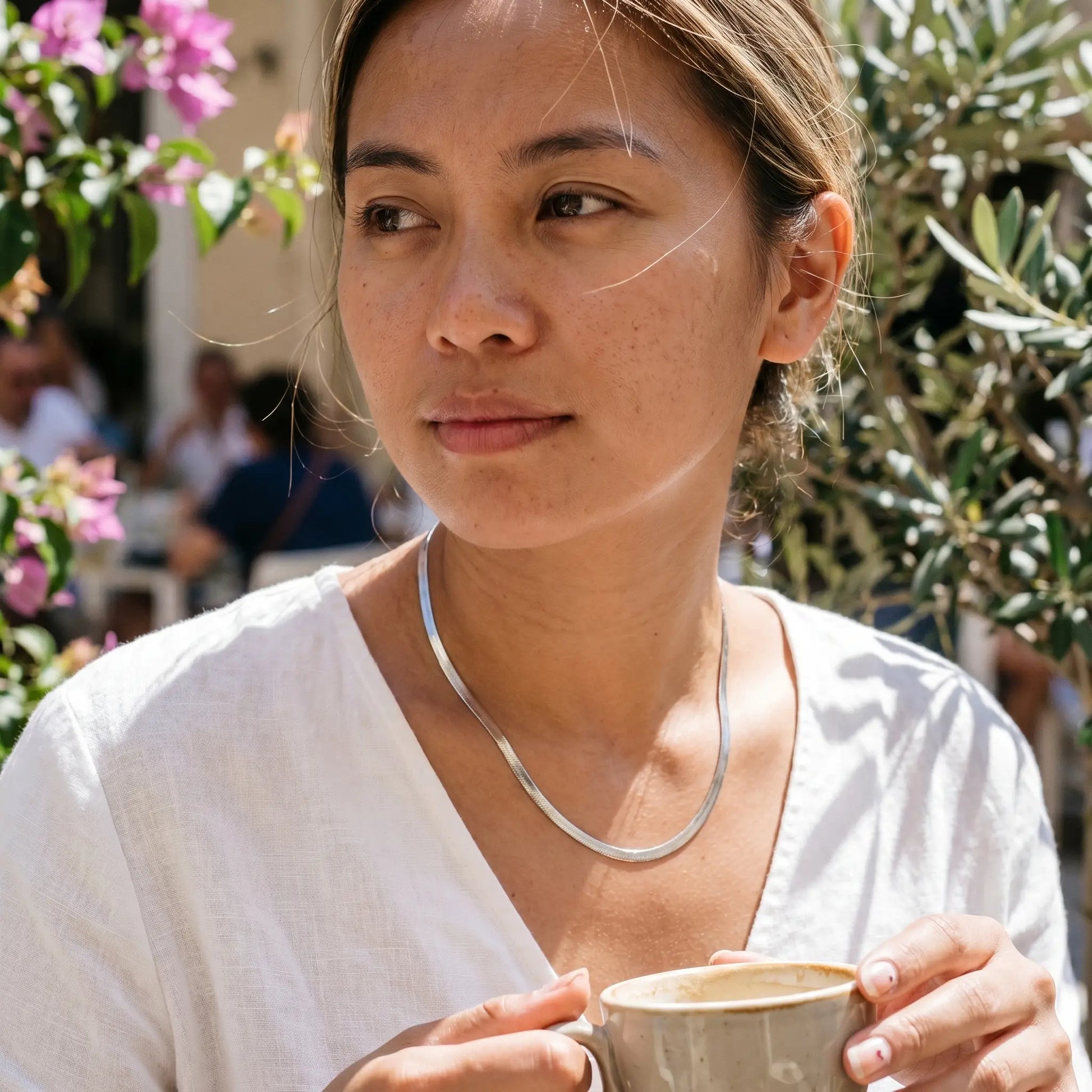 AUREATE 5mm Herringbone silver chain at Mediterranean cafe terrace morning editorial