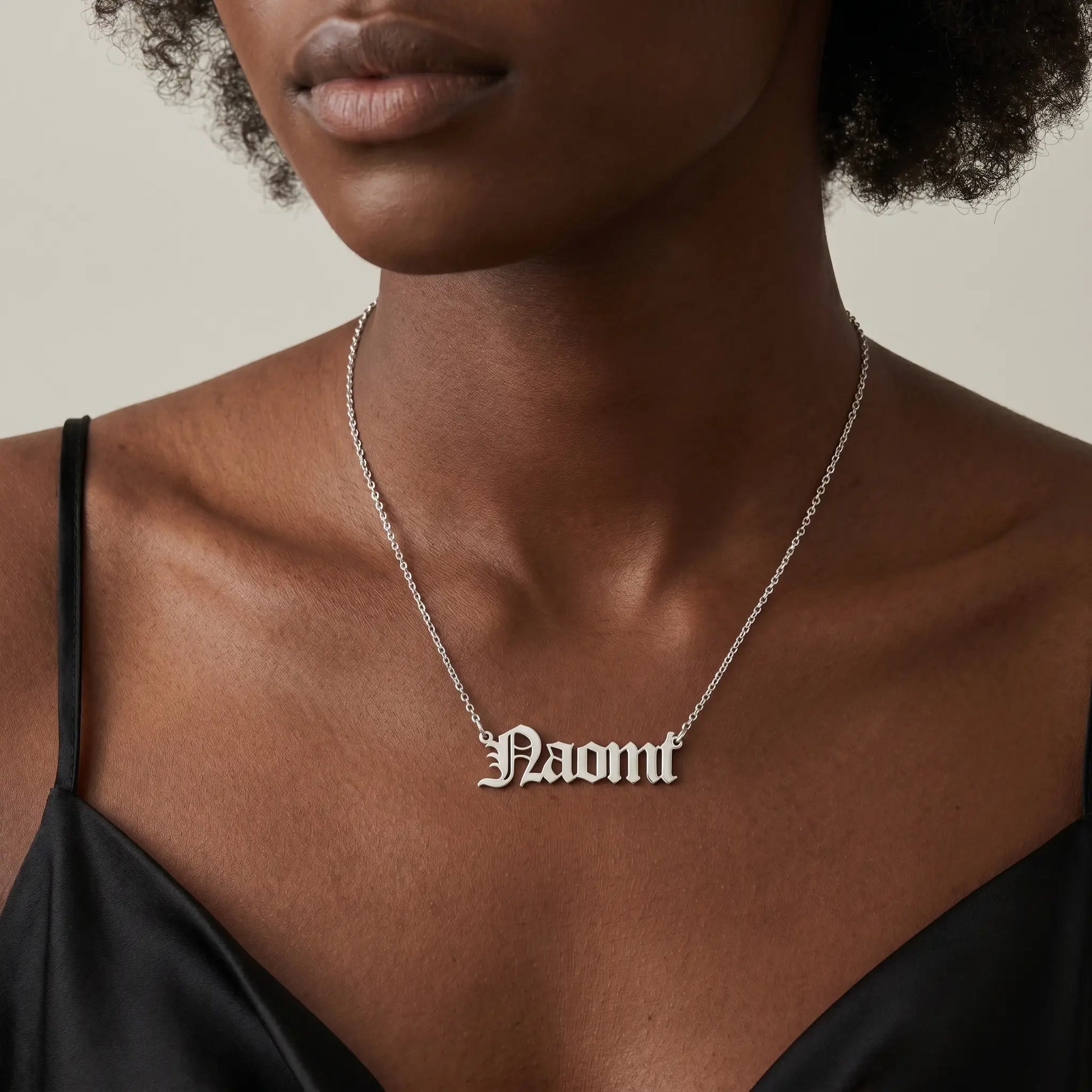 Old English Lettering Name Pendant — Stainless Steel (Silver Tone) — Studio close-up — NAOMI