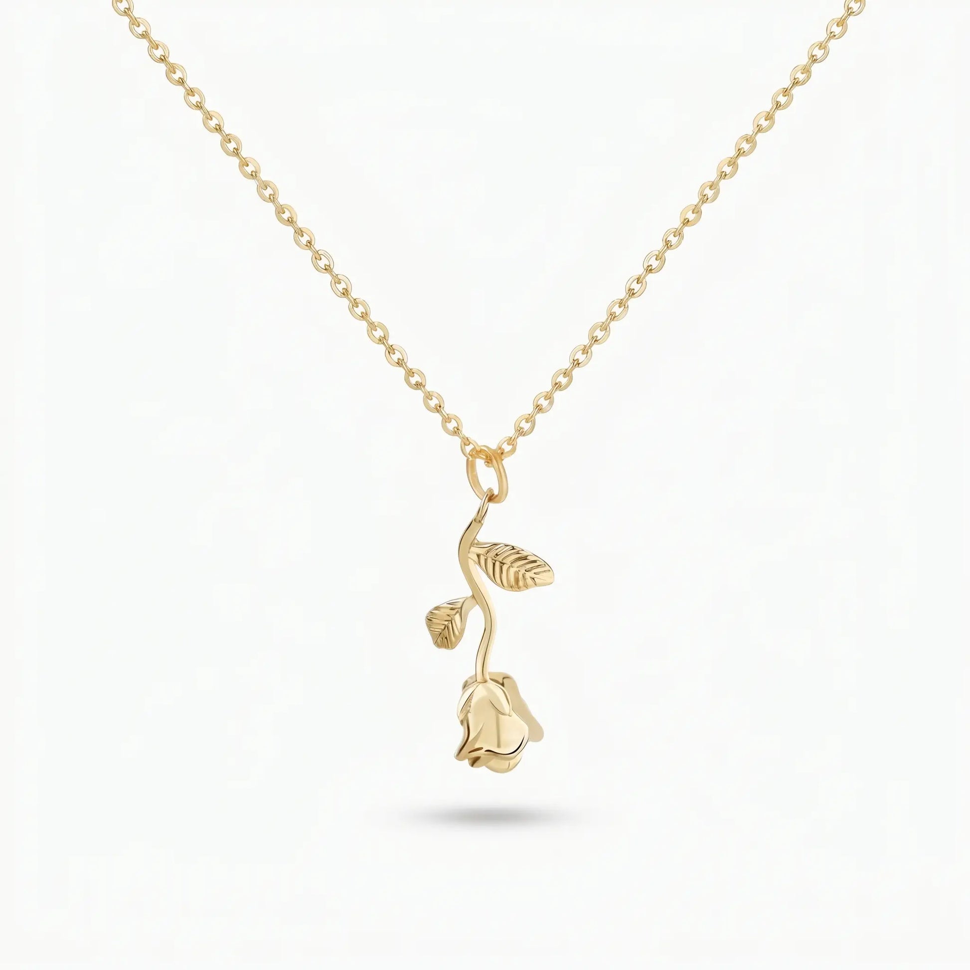 AUREATE Rose Flower Charm Pendant 18K Gold packshot — 3D sculpted long-stem rose with two leaves on a delicate cable chain, isolated on clean white background.