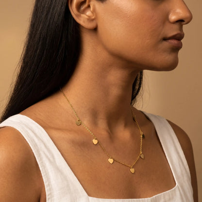 AUREATE Twin Heart Gold Multi-Heart Station Necklace 18K gold mature elegance 3/4 profile editorial
