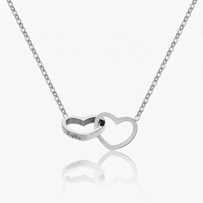 Engraved Double Heart Pendant Silver Stainless Steel packshot by AUREATE, two interlocked hearts on delicate cable chain Sophia engraved on left heart
