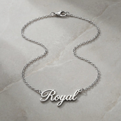 Personalized Script Name Chain silver tone cursive nameplate packshot on cool stone by AUREATE