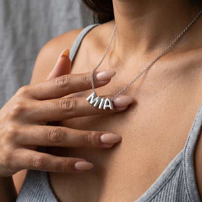 AUREATE Bubble Letter Name Chain Silver Tone MIA hand-to-pendant intimate close-up