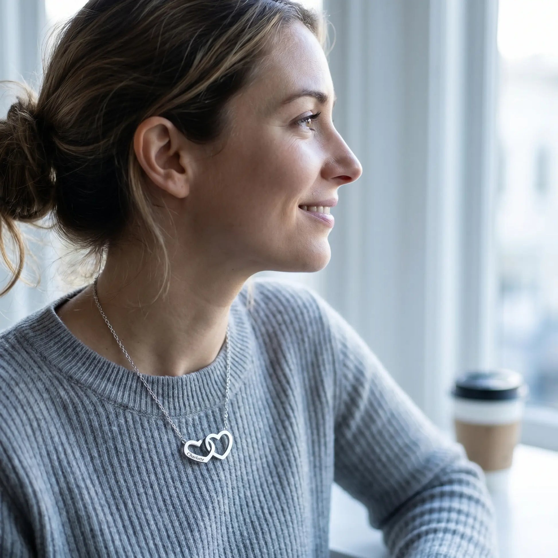 Engraved Double Heart Pendant Silver profile sun-drenched morning Parisienne woman dove-grey crewneck subtle smile by AUREATE