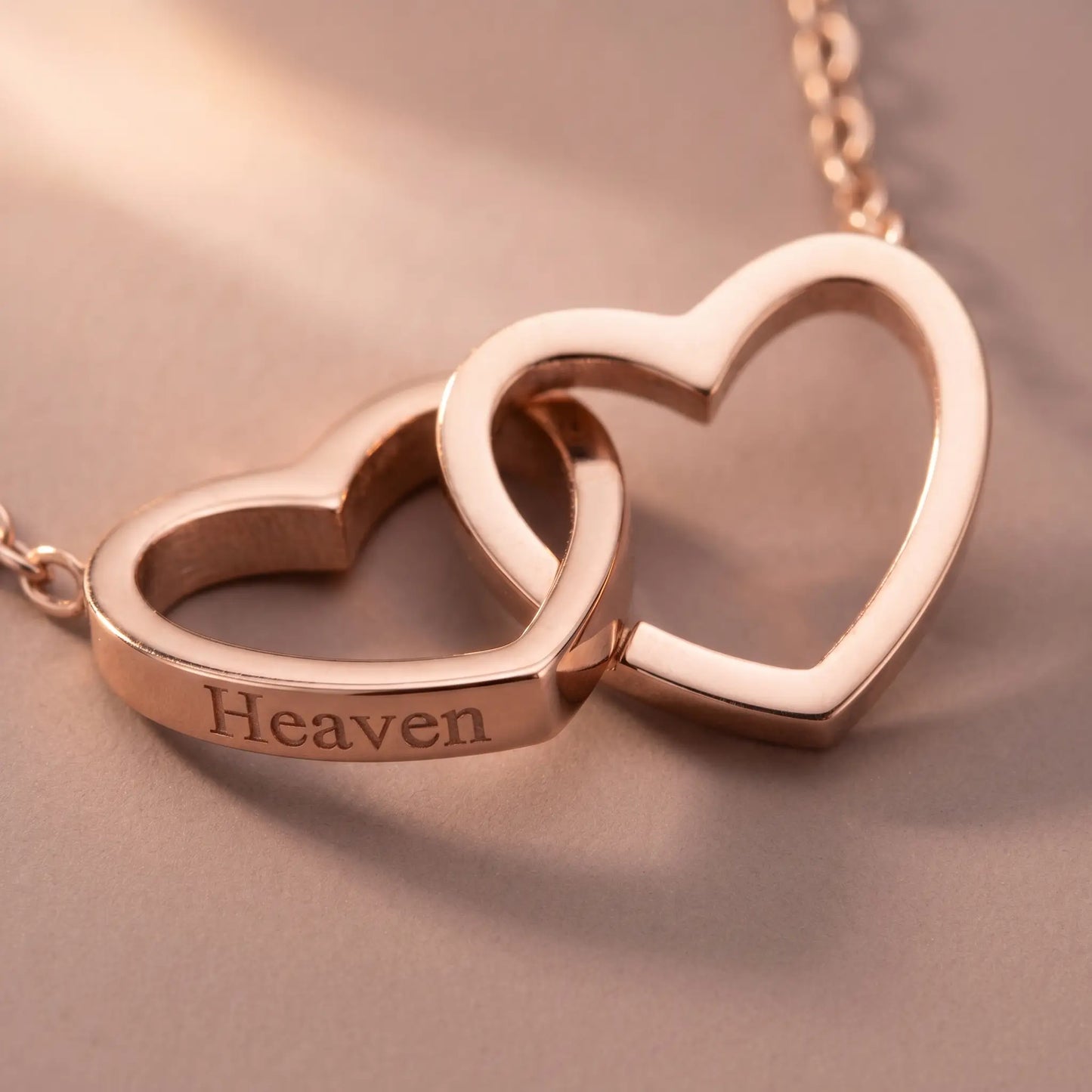 Engraved Double Heart Pendant Rose Gold macro detail by AUREATE, two interlocked open-outline hearts with Heaven engraving soft pink-gold premium craftsmanship