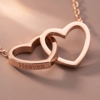 Engraved Double Heart Pendant Rose Gold macro detail by AUREATE, two interlocked open-outline hearts with Heaven engraving soft pink-gold premium craftsmanship