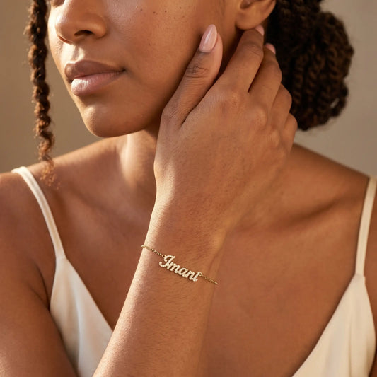Crystal Name Wrist Chain in 18K Gold worn on wrist - dainty cursive crystal pave personalised name bracelet by AUREATE