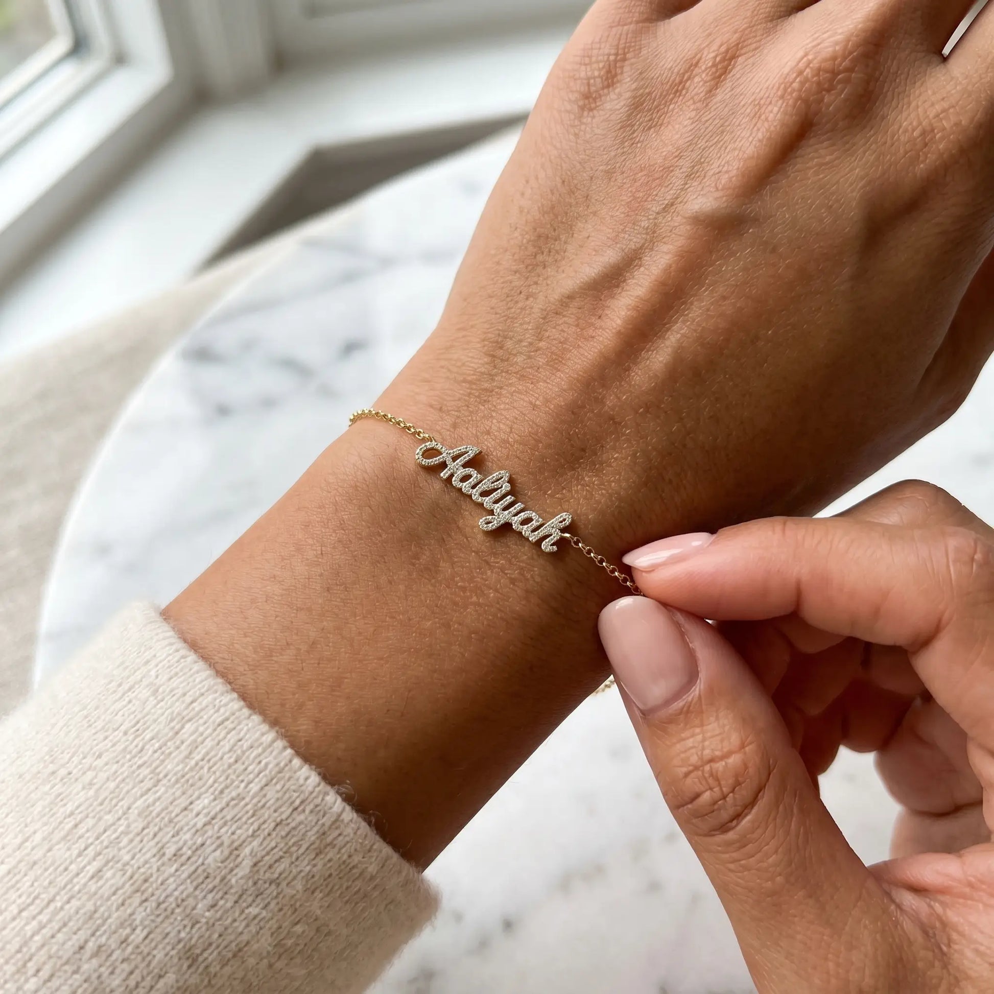 Crystal Name Wrist Chain in 18K Gold tactile wrist close-up - quiet luxury bracelet by AUREATE