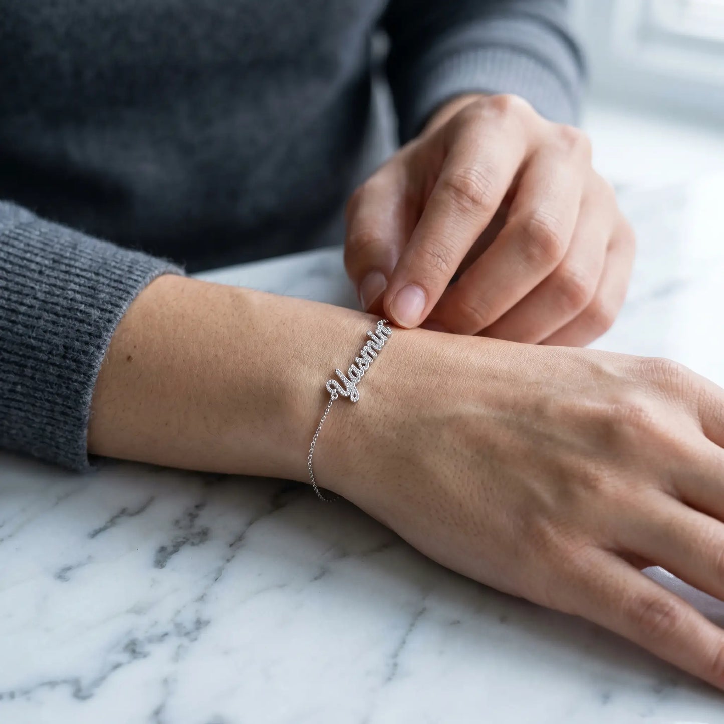 Crystal Name Wrist Chain in Silver tactile wrist close-up - quiet luxury bracelet by AUREATE