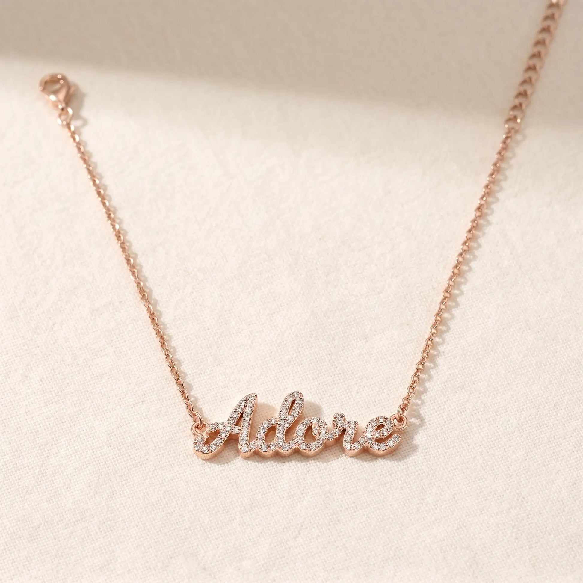 Crystal Name Wrist Chain in Rose Gold packshot - delicate rolo chain with iced cursive nameplate by AUREATE