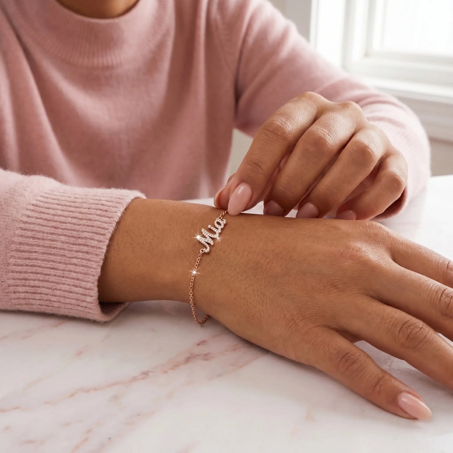 Crystal Name Wrist Chain in Rose Gold tactile wrist close-up - quiet luxury bracelet by AUREATE