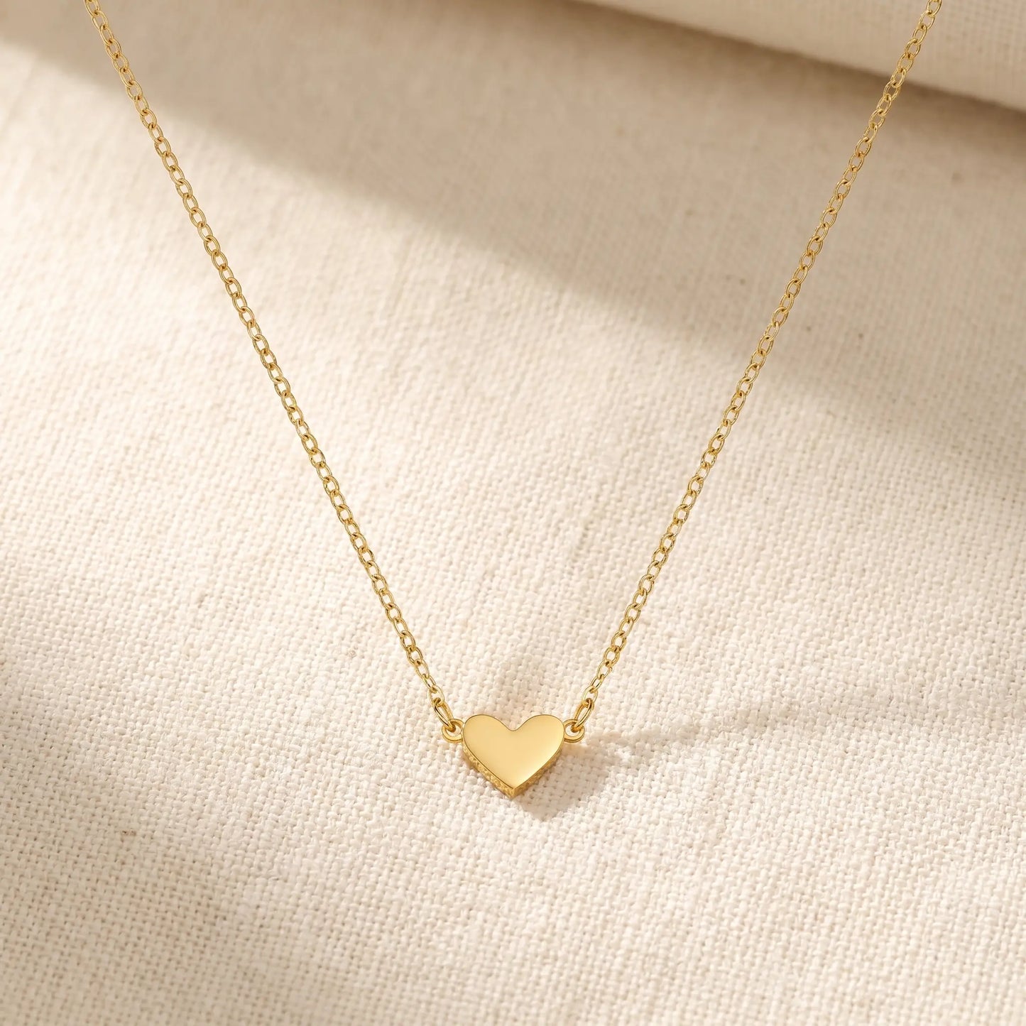 Timeless Heart Pendant Chain by AUREATE in 18K gold packshot on cream linen, V-shape symmetric drape