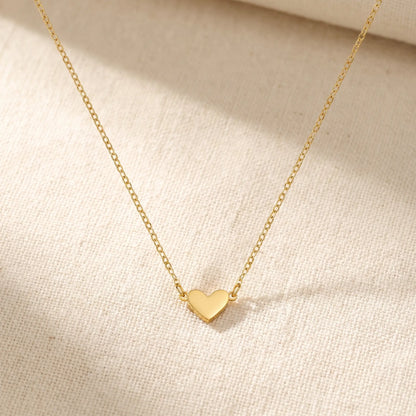 Timeless Heart Pendant Chain by AUREATE in 18K gold packshot on cream linen, V-shape symmetric drape