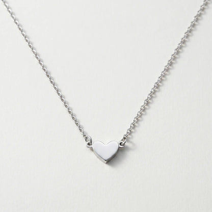 Timeless Heart Pendant Chain by AUREATE in silver tone packshot V-shape symmetric drape on cool ivory