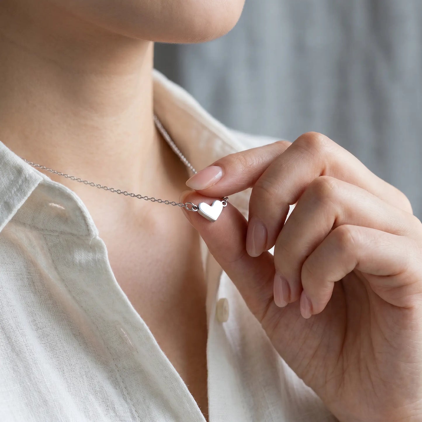 Timeless Heart Pendant Chain by AUREATE in silver tone tender hand-to-pendant intimate moment