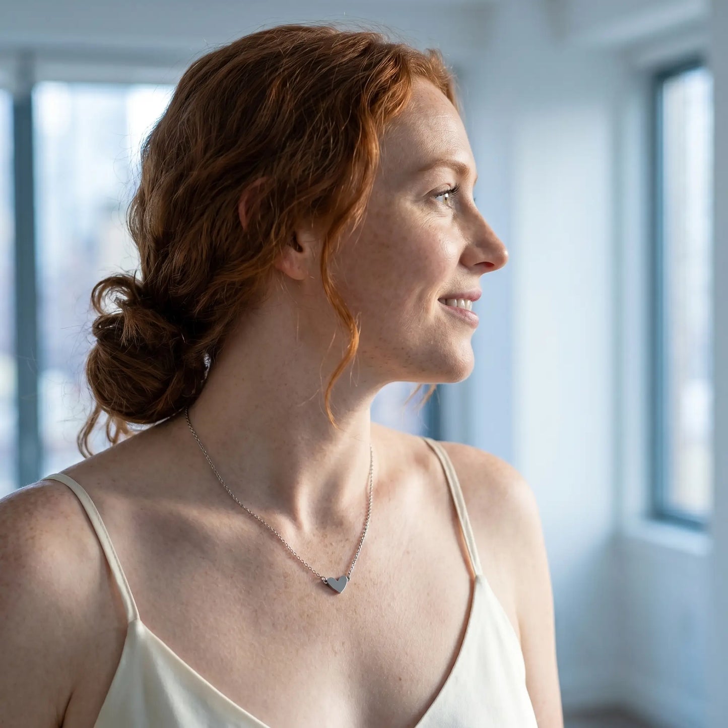 Timeless Heart Pendant Chain by AUREATE in silver tone profile subtle smile NYC loft morning