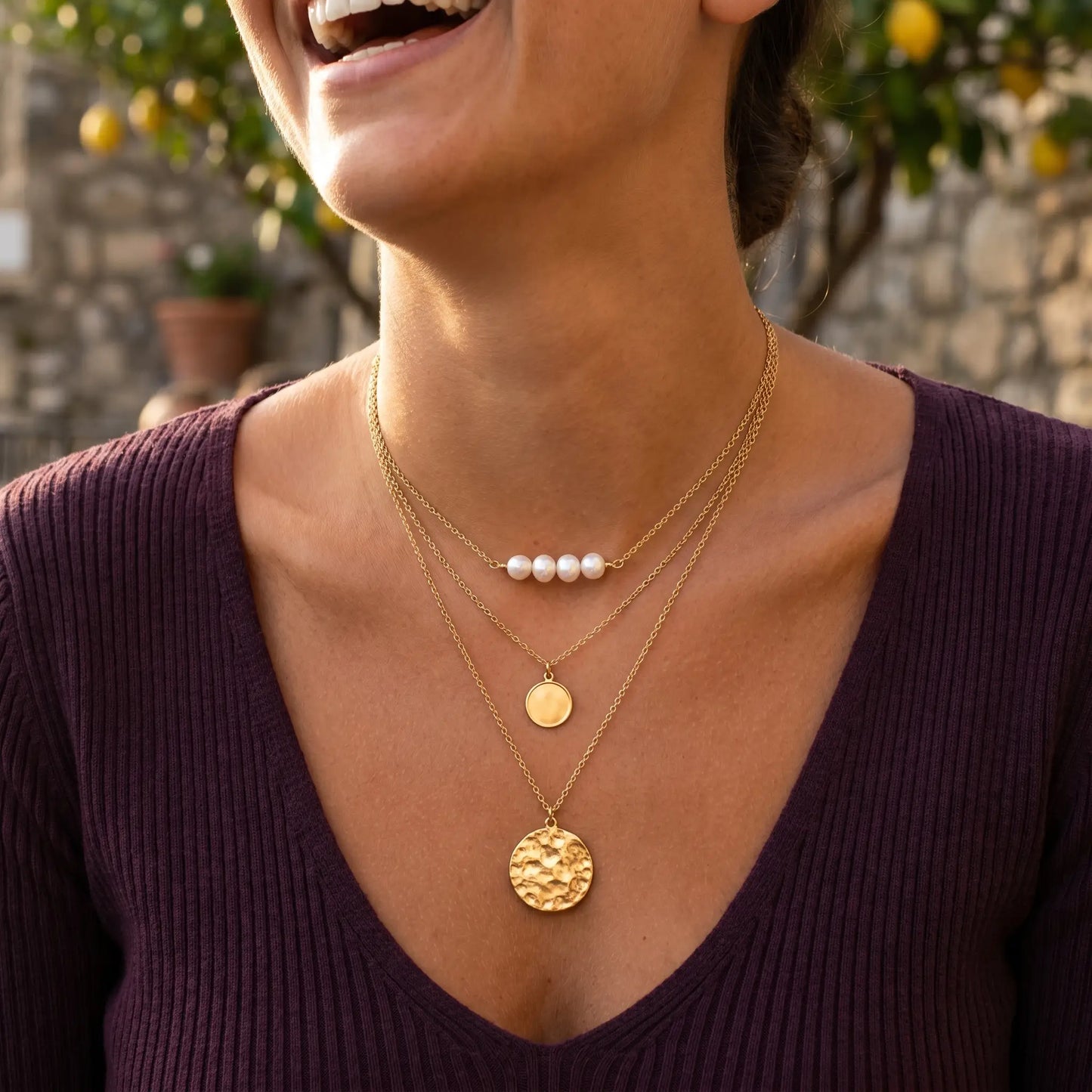 Italian woman laughing wearing gold pearl coin layered necklace set Amalfi cafe