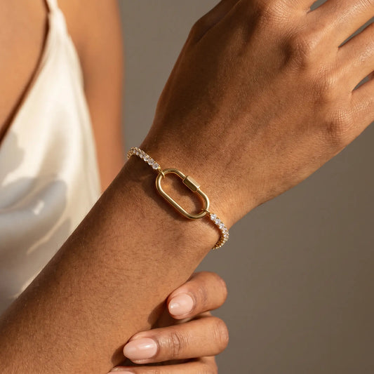 Oval Lock Tennis Bracelet gold worn close-up dorsal wrist