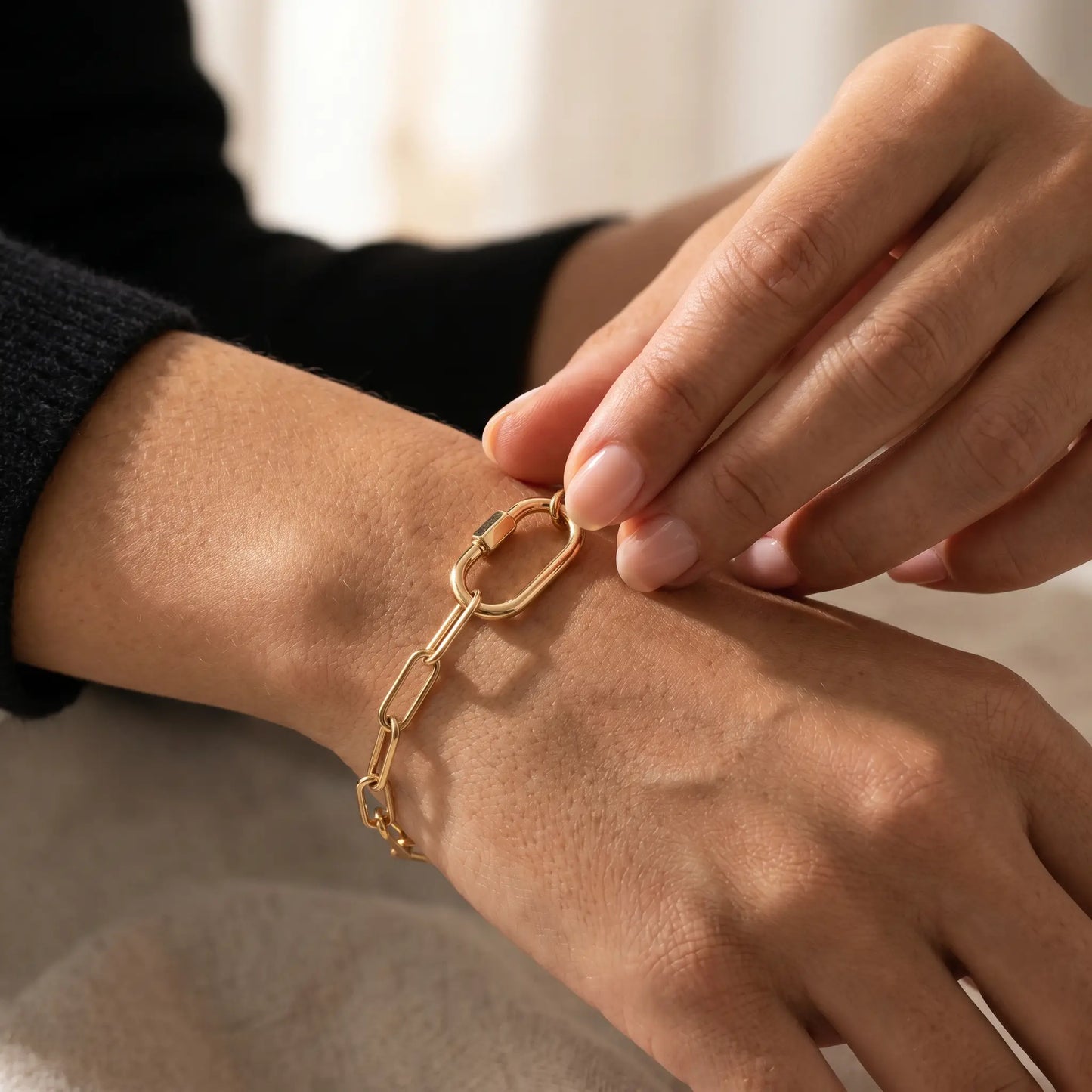Gold paperclip bracelet - intimate hand-to-jewelry close-up daily ritual