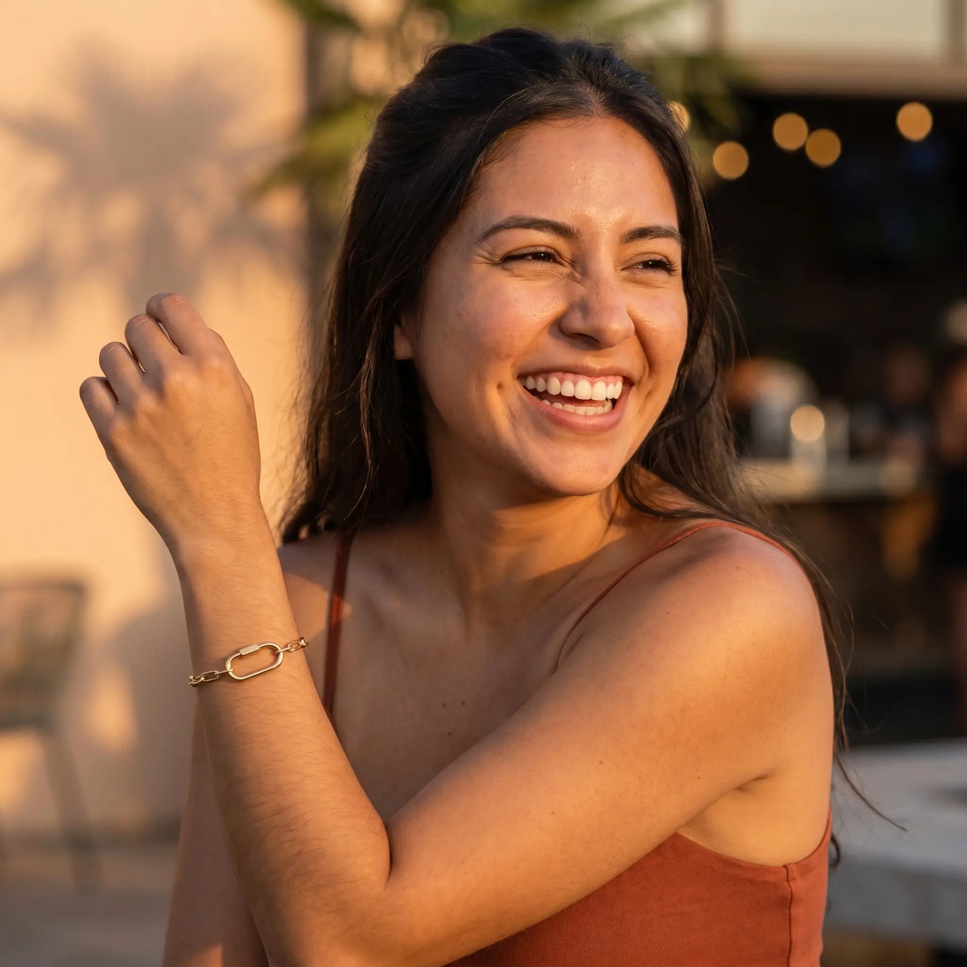 Gold paperclip bracelet worn lifestyle joy laugh moment golden hour