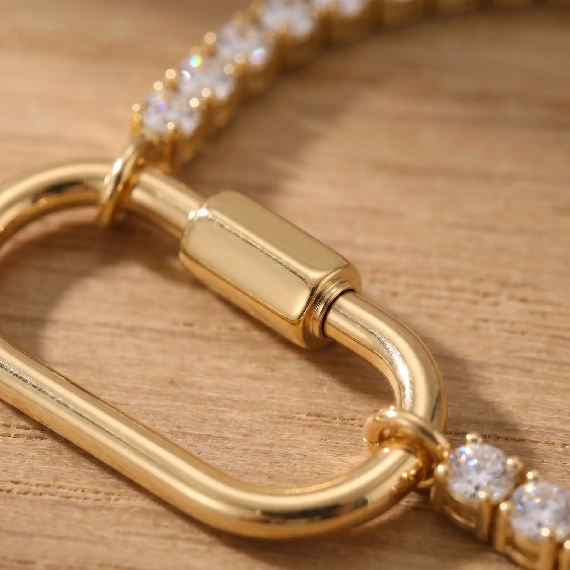 Oval Lock Tennis Bracelet gold macro carabiner cylinder detail