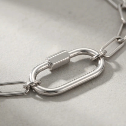 Silver paperclip bracelet macro detail oval carabiner lock pendant
