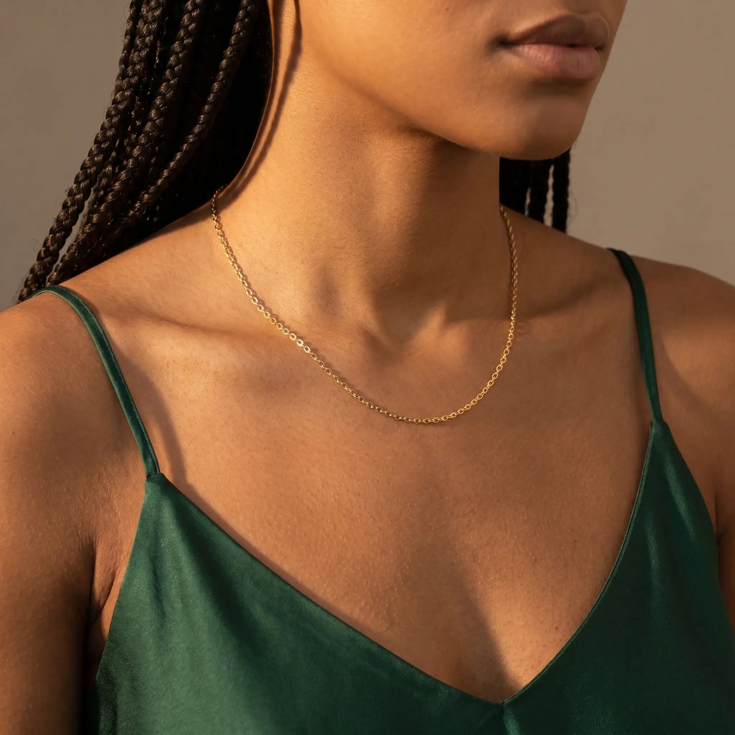 Gold princess chain necklace worn at collarbone studio close-up