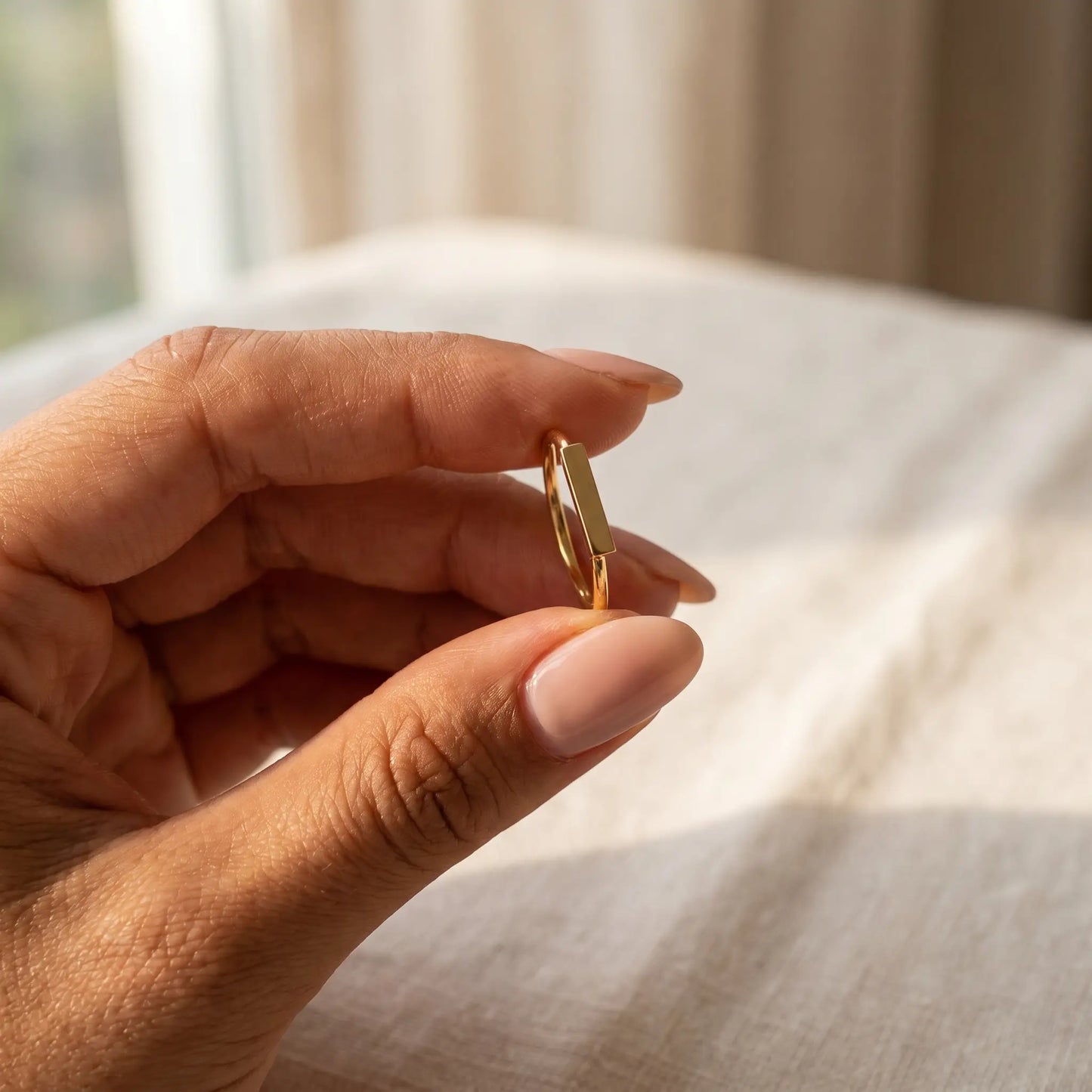 Mini bar ring 18K gold plated held in hand intimate