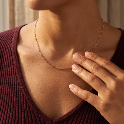 Gold princess necklace lifestyle intimate touch fingertips collarbone