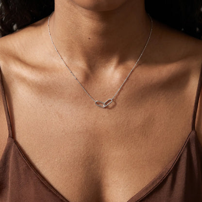 Linked Loop Necklace silver tone worn close-up decollete African American