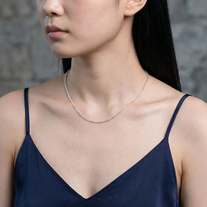 Silver princess chain necklace worn at collarbone studio close-up