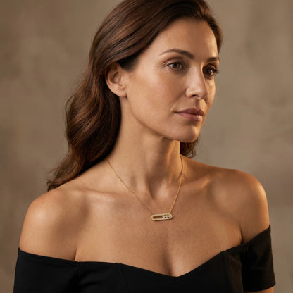 Dainty gold pavé bar necklace styled with black off-shoulder bustier editorial portrait