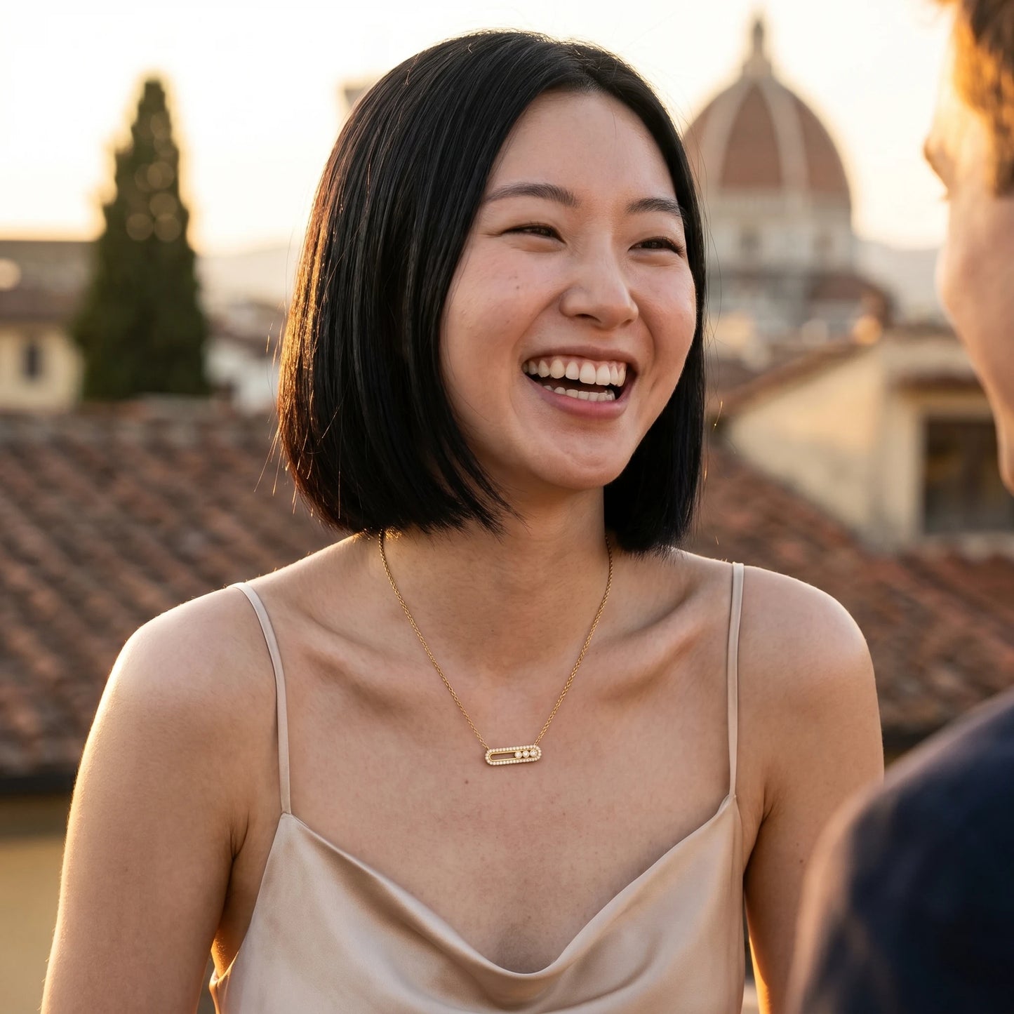 Gold paperclip pendant necklace worn on Italian rooftop golden hour, satin slip dress