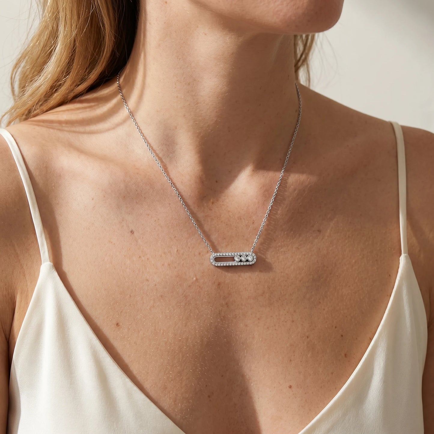 Trio Sliding Pavé minimalist silver necklace worn close-up at suprasternal notch with 3 CZ stones