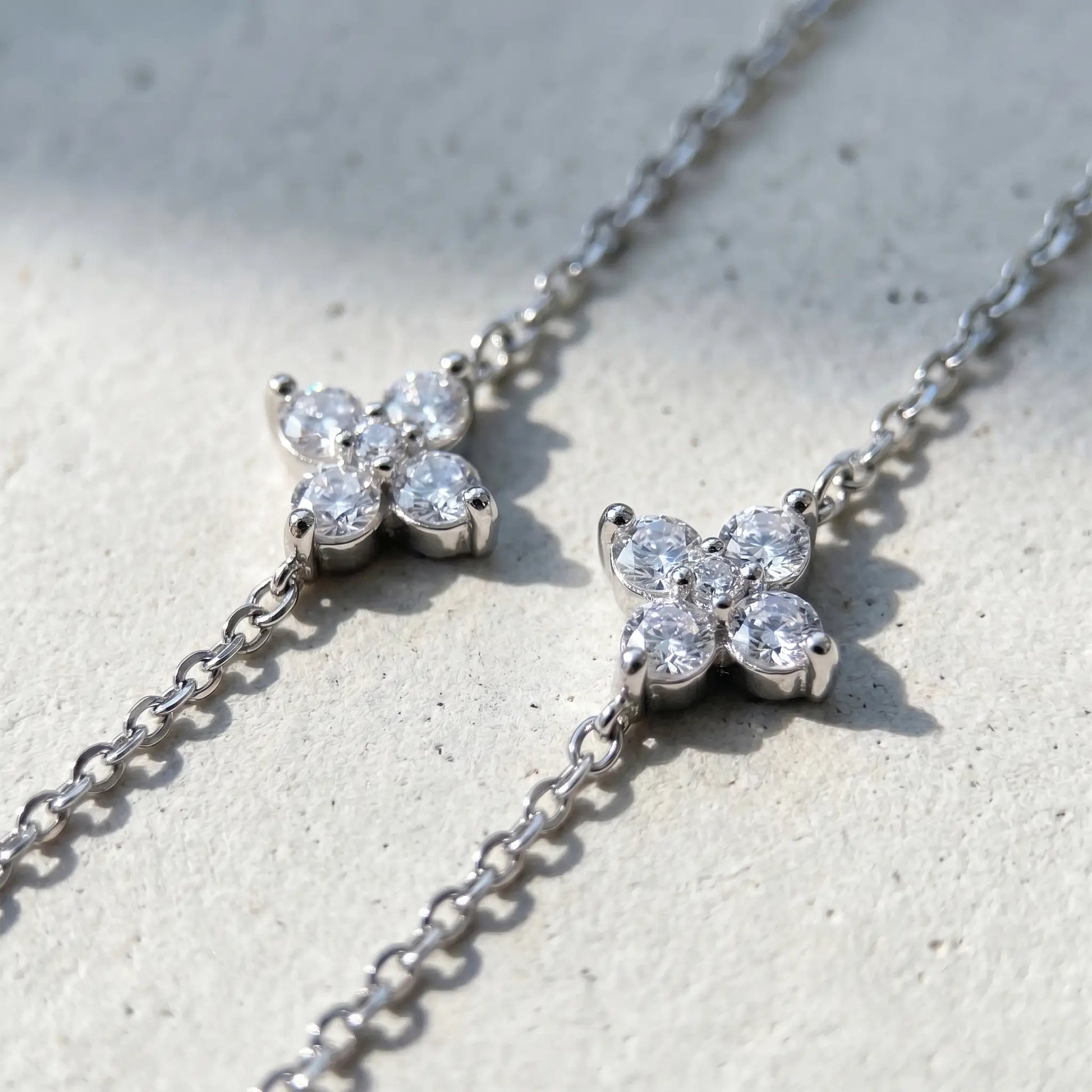 Macro detail silver clover charm 4 petal CZ stones cable chain