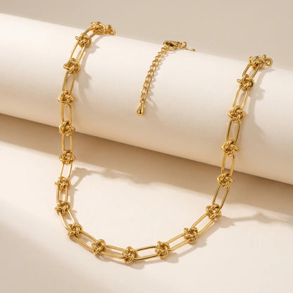 Knot chain necklace gold packshot on cream background
