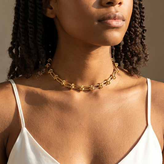 Knot chain necklace gold studio worn close-up on collarbone