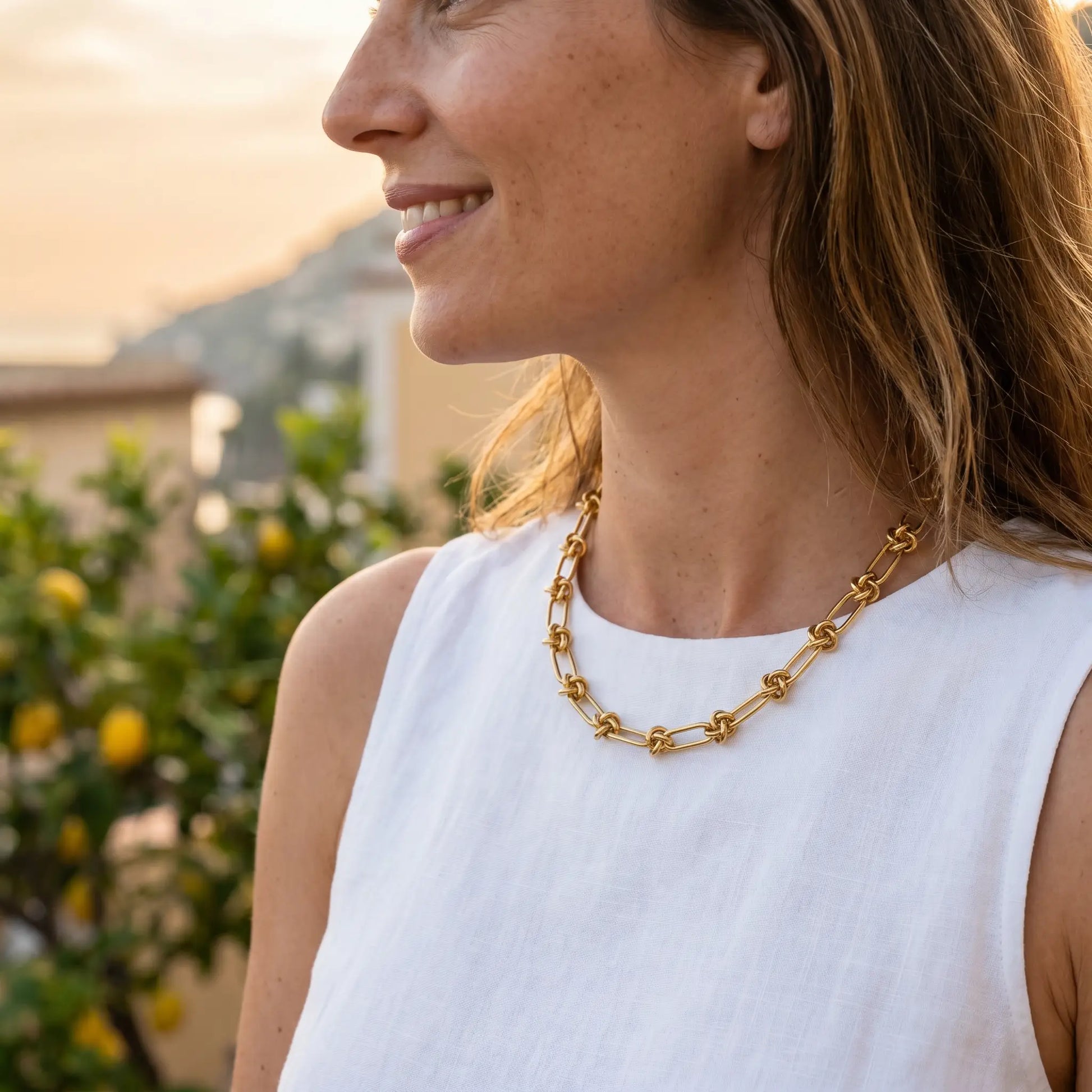 Knot chain necklace gold lifestyle profile aspirational Amalfi terrace