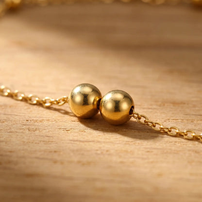 Beaded Station Anklet macro bead pair detail gold finish