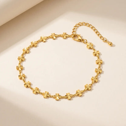Gold daisy anklet packshot white background - dainty 4-petal flower chain with lobster clasp extender