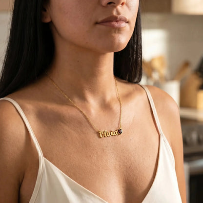 Birth Stone Letter Drop Strand 18K Gold worn close-up tanned model with Olivia cursive name and January Garnet heart birthstone