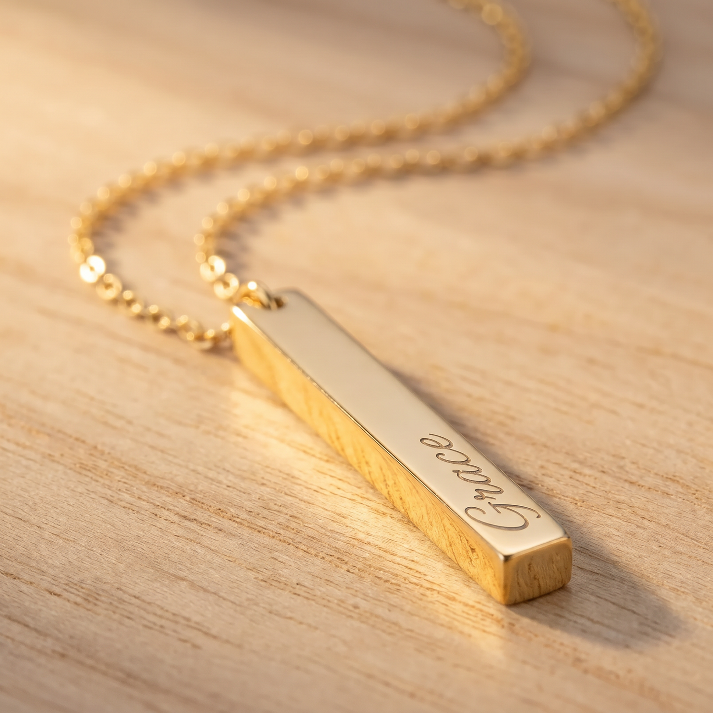 Gold vertical bar name necklace macro detail