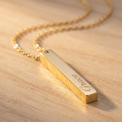 Gold vertical bar name necklace macro detail