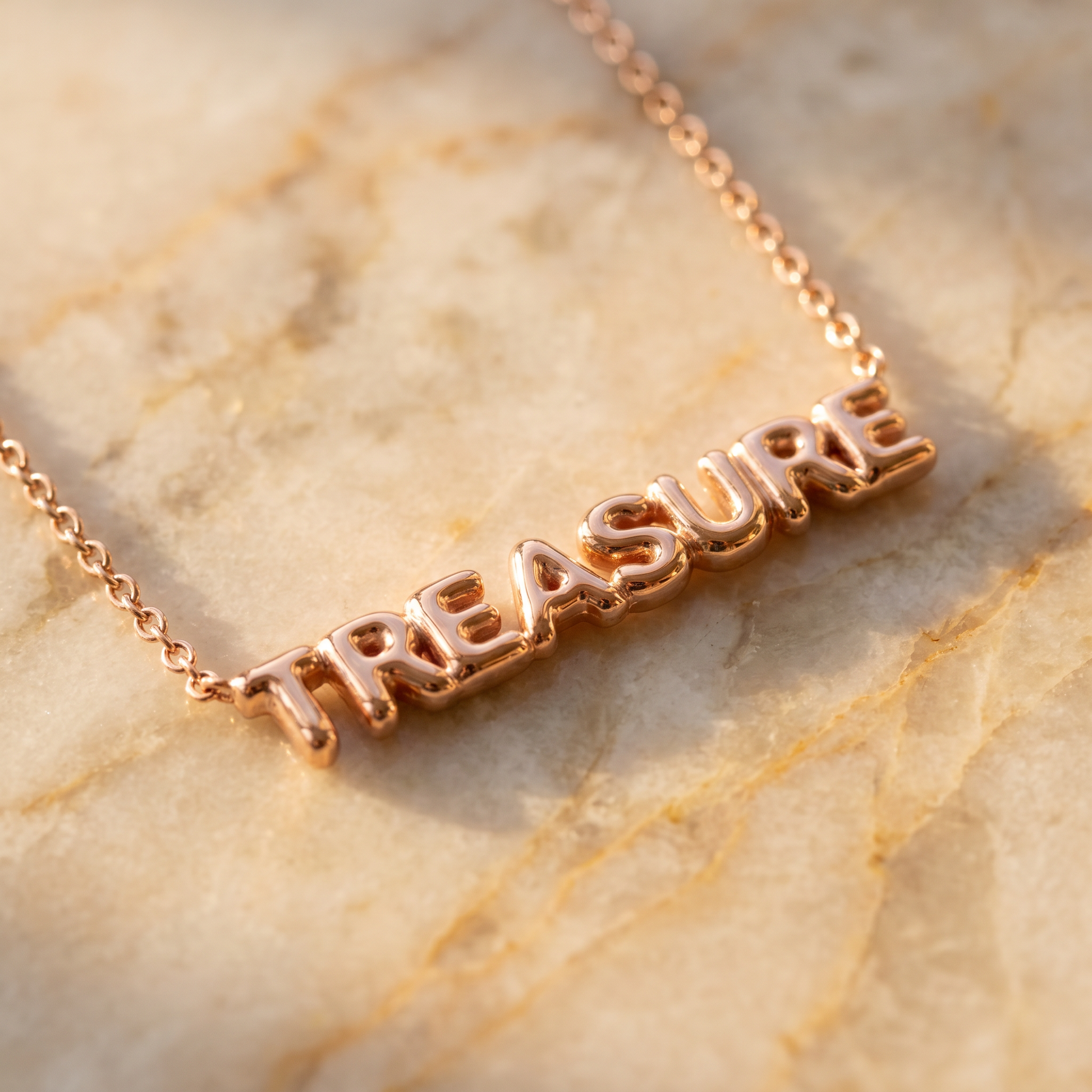 Rose gold puffy bubble-letter name necklace macro detail