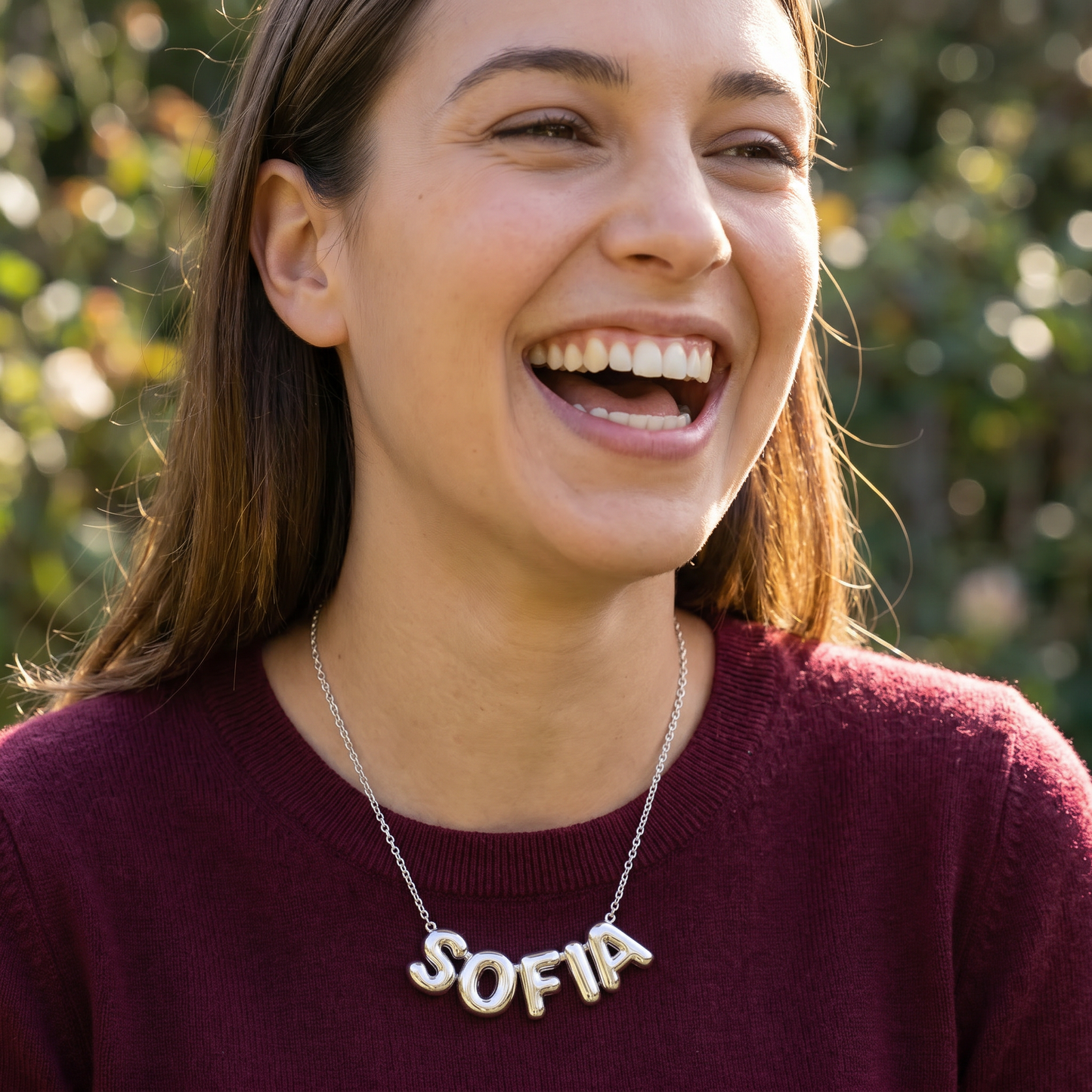 Silver puffy bubble-letter name necklace lifestyle laughing