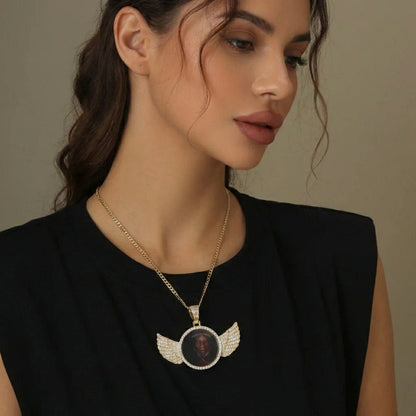 Woman wearing Iced Angel Photo Pendant Necklace by AUREATE, featuring angel wings and a personal photo.