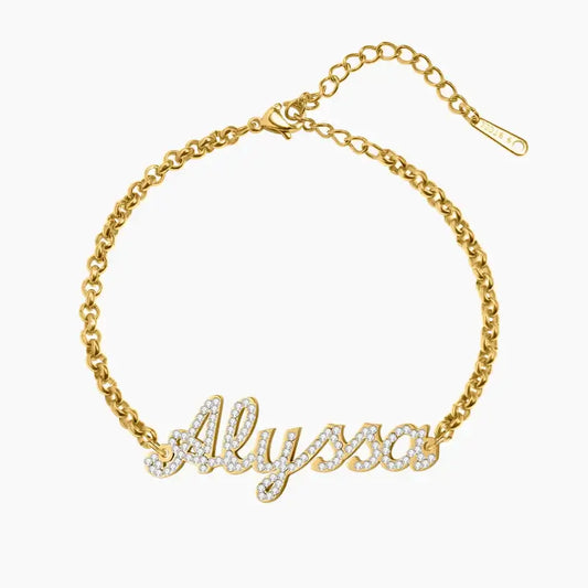Iced Name Bracelet by AUREATE featuring a gold chain and rhinestone name design.